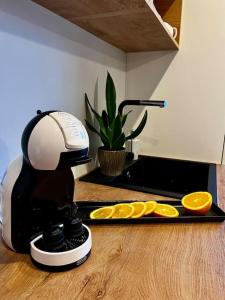 a coffee maker sitting on a counter with orange slices at Seashell Albatross Boutique Apartment in Ķesterciems +25 photos