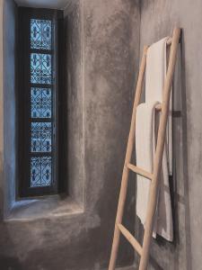 a ladder in a room with a window at Riad Atay in Marrakesh