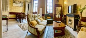 a living room with a couch and a table at Gîte de la Cigale in Burzet +26 photos
