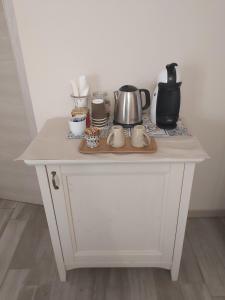 a white cabinet with a counter top with appliances on it at Poggio Bardolino in Bardolino