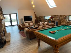 a living room with a pool table in it at Les cailloux in Saint-Urcize