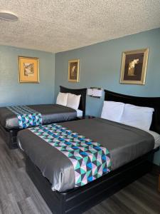 2 camas en una habitación de hotel con 2 camas en Kansas Inn, en Independence