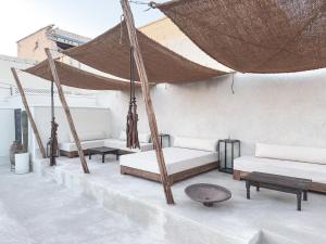 a patio with two beds and a hammock at Riad Atay in Marrakesh