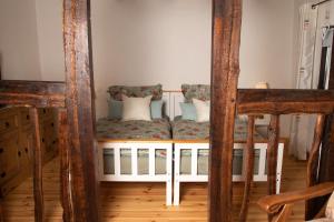 a bed in a room with two chairs at Fachwerk Ferienhaus Elz in Elz