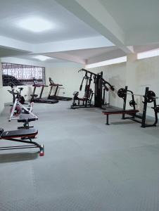 a gym with several tread machines in a room at Wanderstay kenya in Nairobi