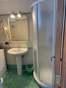 a bathroom with a sink and a shower at De Vivo Realty - Seacliff Heaven Positano in Positano +55 photos