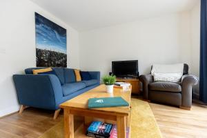 a living room with a couch and a table at BRIARS CLOSE - Four Bed Property on the Edge of the Peak District National Park in Buxton