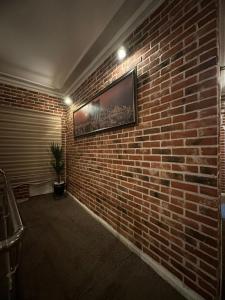 a room with a brick wall with a television on it at Konak Otel Suriçi in Diyarbakır