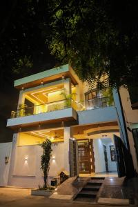 a large white building with a balcony at night at Anirudh Homestay in Agra