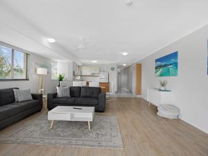 a living room with a couch and a table at Riviera Resort in Hervey Bay