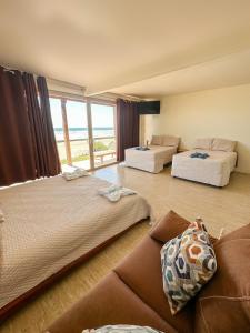 pokój hotelowy z 2 łóżkami i kanapą w obiekcie Punta Mango Surf Resort w mieście Jucuarán