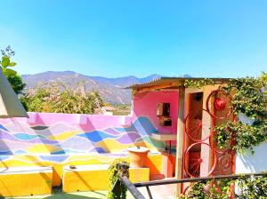 a house with a colorful mural on the side of it at Amura Hostal in Antigua Guatemala