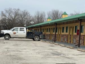 a white truck parked in front of a building at Kansas Inn in Independence