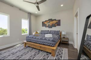 a bedroom with a bed and a ceiling fan at Luxury four-story Home with Rooftop views, 10min to Downtown! Sleeps 12! in Nashville
