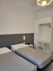 Postel nebo postele na pokoji v ubytování Hotel Piccadilly