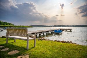 a bench sitting on the grass next to a dock at Widokówka 13 in Mikołajki
