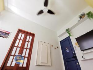 a ceiling fan and two doors in a room at Studio Sand & Blue Copacabana Beach in Rio de Janeiro