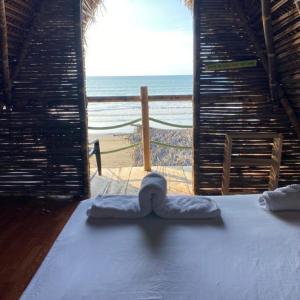 a room with a bed with a view of the beach at Chowa lodge in Nuquí