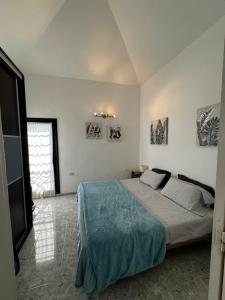 a bedroom with a bed with a blue blanket at Sotavento 28 in Los Cristianos +30 photos