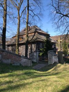 an old church with a cross in front of it at Penzion Budopartner in Jívka