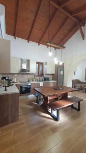 a large kitchen with a wooden table in a room at Anasa Residence - The Farm house in Varípetron