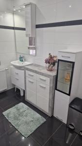 a white bathroom with a sink and a counter top at CT Apartment Wurzen in Wurzen