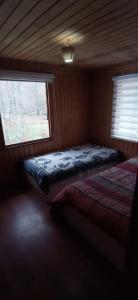 Postel nebo postele na pokoji v ubytování HOSTAL CARHUELLO