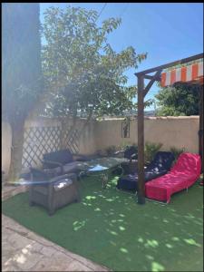 a backyard with couches and a gazebo at Maisonnette les fabrettes in Marseille