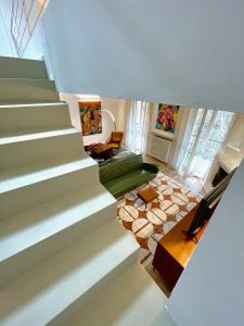 a staircase in a house with a living room at 149 BORGO TICINO SUITE Attico di Lusso con Terrazzo e Parking Privato in Pavia