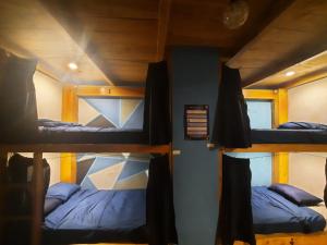 a group of bunk beds in a room at Amura Hostal in Antigua Guatemala