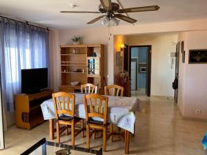 a dining room and living room with a table and chairs at BRISA Solo FAMILIAS in Los Mártires