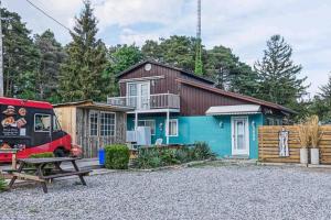 a house with a red van parked in front of it at Sunset Cottage, 3 min walk to beach, sleeps 7 in Lambton Shores