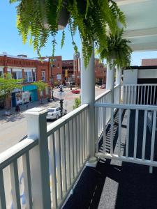 a balcony with a white railing and a street at The Grove Hotel in Kingsville