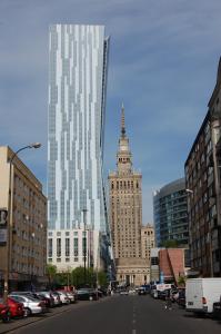 a city street with a tall building with a clock tower at Apartament Centralny in Warsaw