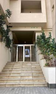 a building with stairs leading up to a door at F4 moderne au centre ville d'oran in Oran