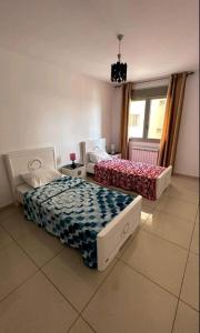 two beds sitting in a room with at F4 moderne au centre ville d'oran in Oran