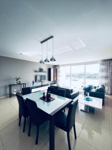 a dining room and living room with a table and chairs at Valletta View Apartment - Wish Malta in Sliema