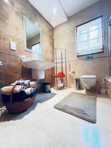 a bathroom with a sink and a toilet at Valletta View Apartment - Wish Malta in Sliema