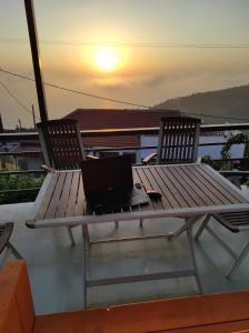 a laptop sitting on a picnic table on a balcony at Ionian Balcony Studio in Athani