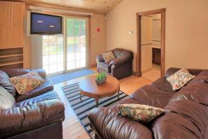 ein Wohnzimmer mit 2 Sofas und einem TV in der Unterkunft Sunset Getaway, Cozy 5 people, 2 min to beach! in Lambton Shores