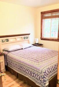 Schlafzimmer mit einem Bett und einem Fenster in der Unterkunft Sunset Getaway, Cozy 5 people, 2 min to beach! in Lambton Shores