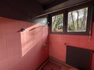 a pink tiled bathroom with a window and a shower at Maison bord de mer proche des Sables d'Olonne in Talmont +16 photos