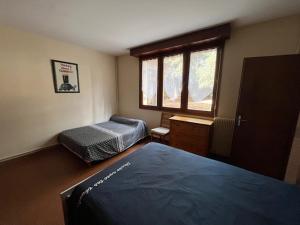 a bedroom with a bed and a window at Maison bord de mer proche des Sables d'Olonne in Talmont