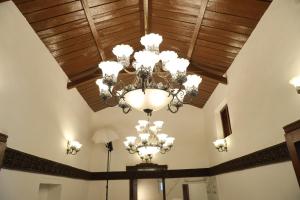 a ceiling with a chandelier in a room at Pear Tree Luxe Entire 3BHK Villa - Only For Family in Kotagiri