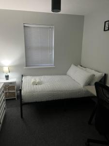 a bedroom with a bed with two shoes on it at Apartment 4 Oak Villa in Belfast