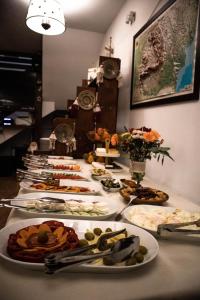 a table with many plates of food on it at Dorul Pescarului in Curtea de Argeş