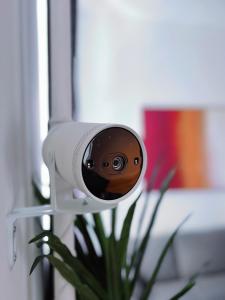 a security camera in front of a plant at Inner City Design Loft in Innsbruck