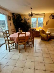 a dining room with a table and chairs at Retour aux sources in Ventron