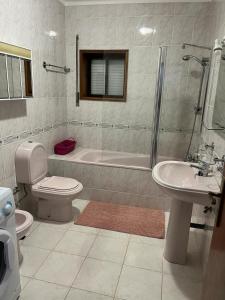 a bathroom with a toilet and a tub and a sink at Alojamento, Chelas Rural AL in Mirandela