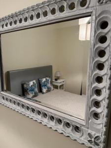 a mirror with a bed in a room at Alojamento, Chelas Rural AL in Mirandela